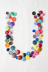Letter U of the alphabet of buttons of various shapes and colors
