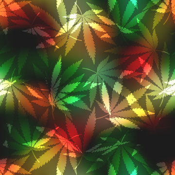 Cannabis leafs on blur rastafarian background.