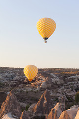 Yellow balloons flying in sky, sunrise time