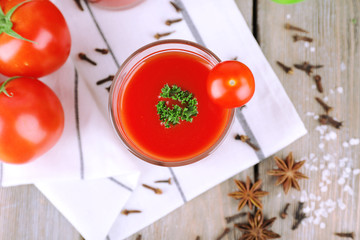 Tomato juice in glass and fresh vegetables