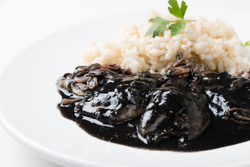 Squid in ink with rice and parsley