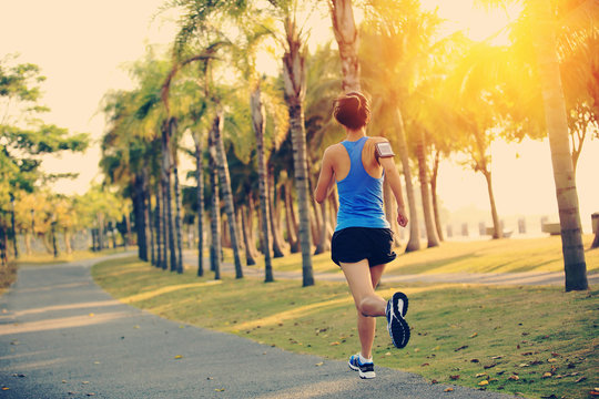woman runner running at tropical park