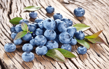Blueberries over old wooden table.