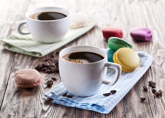 Cup of coffee and french macaron.