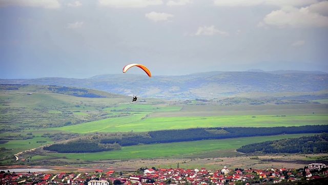Following Parachute above urban village
