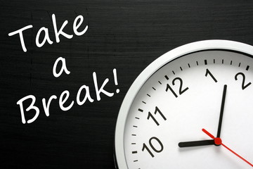 Reminder to Take a Break beside a modern office clock