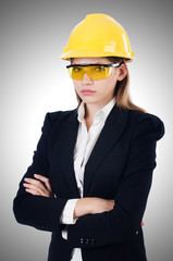 Young businesswoman with hard hat on white