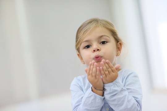 Cute Little Girl Blowing Kisses Away