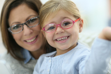 Portrait of mother and daughter wearing eyeglasses
