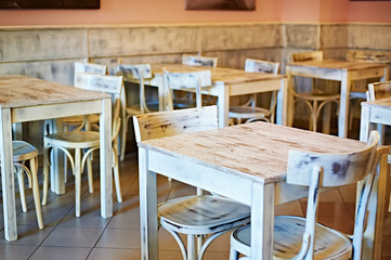 Wooden white tables in a retro cafe