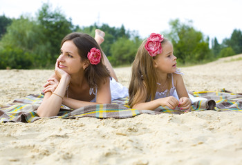 Mother and daughter having a rest on a beach