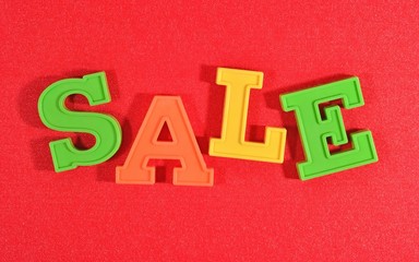 Sale written by colorful letters on a red