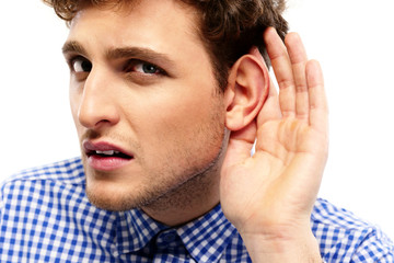 Portrait of young casual man which overhears conversation