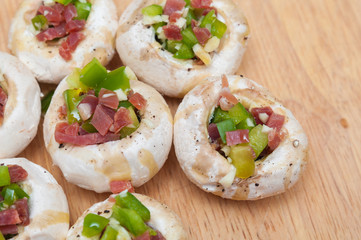 Preparing mushrooms stuffed with ham and pepper