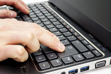 Hand typing on laptop