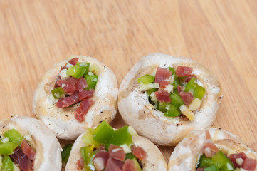 Preparing mushrooms stuffed with ham and pepper