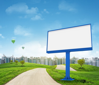 Tall buildings, green hills and road with large billboard