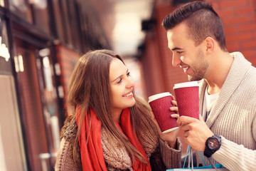 Young couple with coffee shopping in the mall