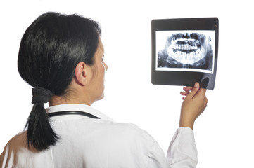 Dentist checking x-ray at dental clinic