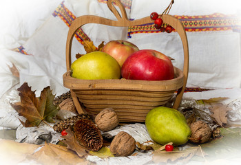 Autumn theme. Apples in a basket and walnuts