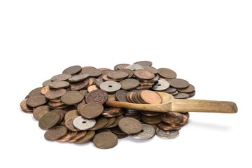 pile of danish coins on white background with a wooden spoon