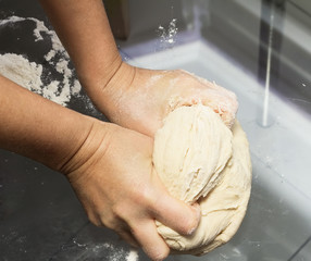 Hands kneading a dough