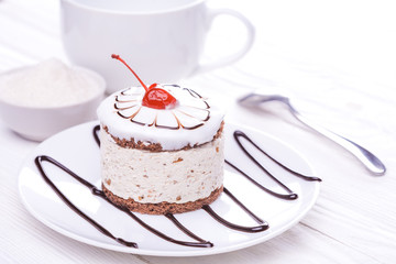 cherry cupcake on white wooden table