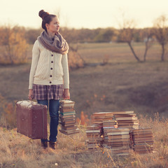 Hipster girl holding a suitcase