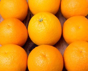 many fresh oranges on wooden background