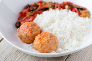 Spanish Meatballs albondigas with vegetables and cooked rice