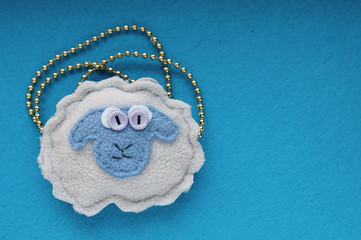 Sheep handmade on a blue background