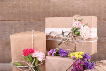 Beautiful gifts with flowers, on old wooden background