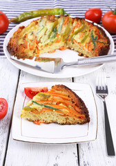 Piece of casserole with vegetables on plate on table close-up