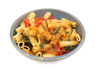 Rigatoni with vegetables with a cheese sauce in bowl
