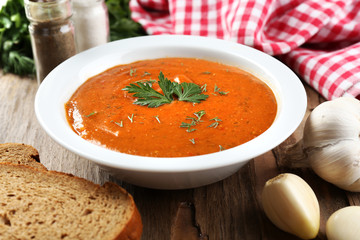 Delicious lentil cream-soup on table close-up