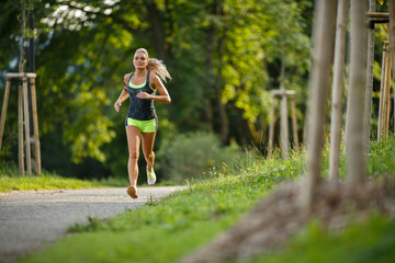Young lady running. Woman runner running through the park - 73318153