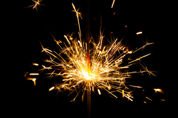 Fototapeta premium Christmas sparkler on black background. Bengal fire