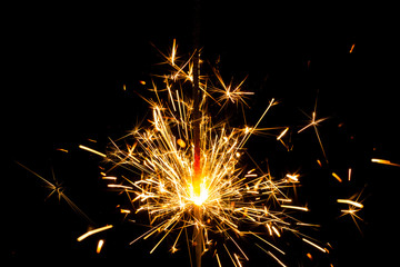 Fototapeta premium Christmas sparkler on black background. Bengal fire