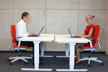 business couple  in correct sitting posture at workstations