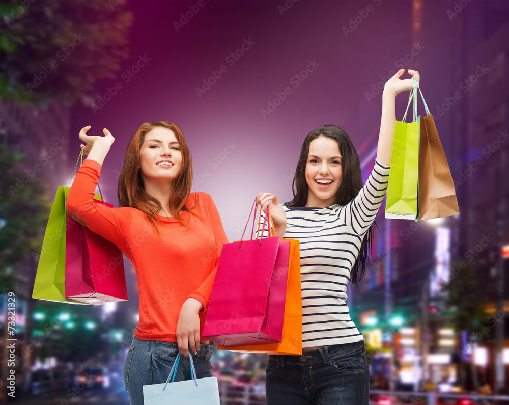 Wall mural two smiling teenage girls with shopping bags