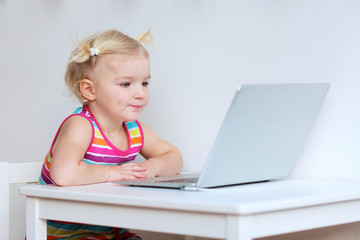 Toddler girl using laptop