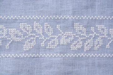 Tapeten Detail van een grijs blauw tafellaken © trinetuzun