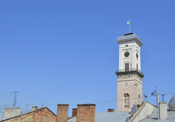 Fototapeta premium horologium above building roofes