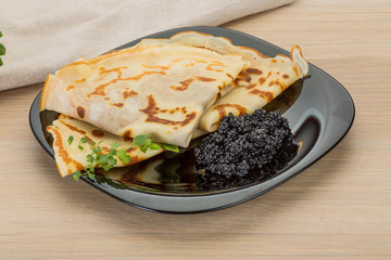 Pancakes with black caviar
