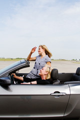 Two women driving a convertible