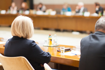 blond hair woman at conference table