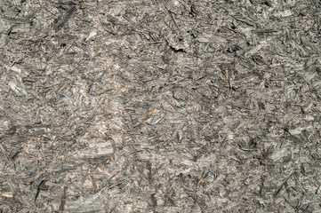 Weathered oriented strand board surface closeup as background