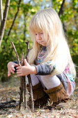 Cute Little Girl Playing with Dry Sticks