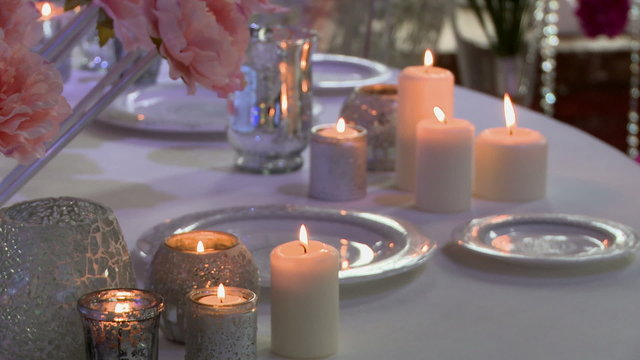 Lighted candles on wedding table, close-up
