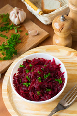 Traditional Russian salad with grated beetroot and garlic